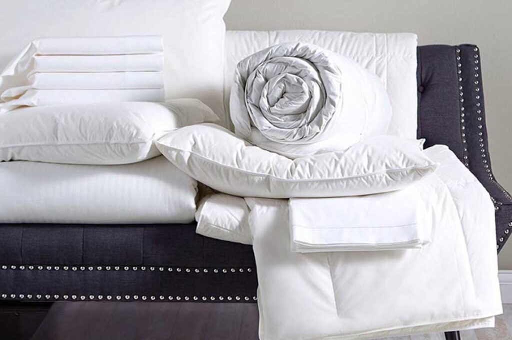 Stacked white hotel bed linen
