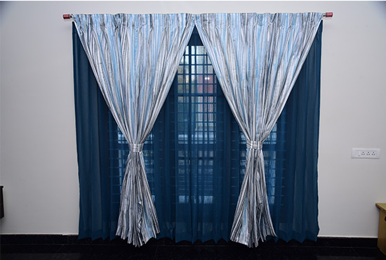 Deep blue blackout curtains with grey patterned sheers