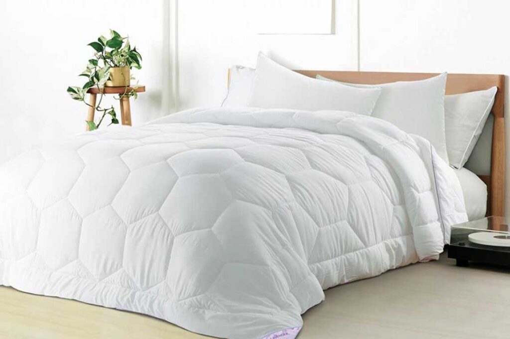 White quilted comforter on a bed