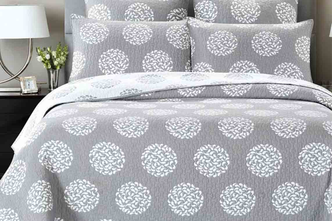 Grey printed bedspread on a double bed